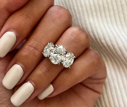 Close-up of a hand wearing a diamond oval cut womens engagement ring statement propose wife girlfriend